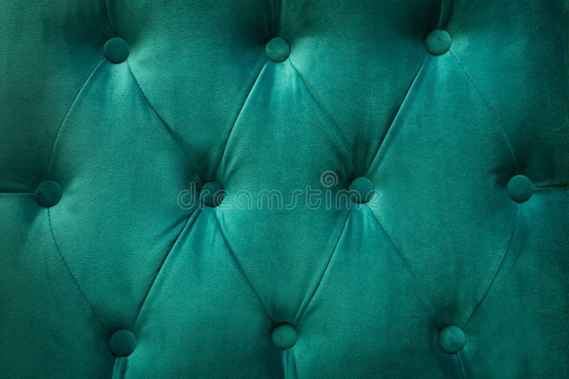 Quilted velvet green fabric as a background. Quilted velvet green fabric as a background